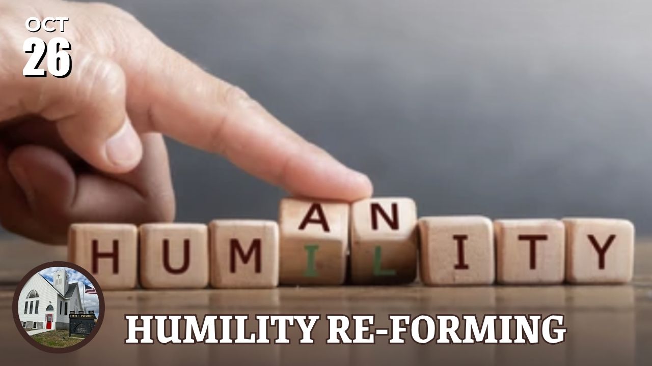 letter blocks spelling HUMANITY with hand tipping back AN